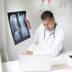male doctor showing chest x-ray result to his patient virtually