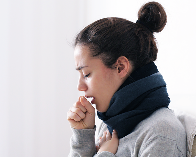 A woman coughing.